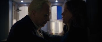 Movie still from “The Woman in the Window” (2021), directed by Joe Wright – A man and a woman face to face in a dark room; Close Up shot, Over the shoulder angle