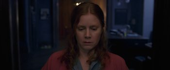 Movie still from “The Woman in the Window” (2021), directed by Joe Wright – A person with her eyes closed; Close Up shot, High angle