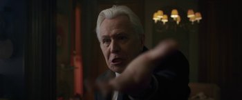 Movie still from “The Woman in the Window” (2021), directed by Joe Wright – An older man in a suit and white hair; Close Up shot, Low angle
