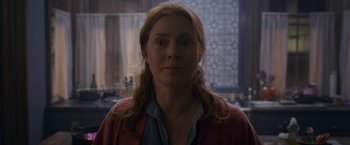 Movie still from “The Woman in the Window” (2021), directed by Joe Wright – A person with long red hair; Close Up shot, Over the shoulder angle