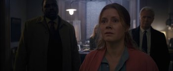 Movie still from “The Woman in the Window” (2021), directed by Joe Wright – A woman standing next to a man in front of a table; Close Up shot, Over the shoulder angle