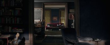 Movie still from “The Woman in the Window” (2021), directed by Joe Wright – A living room filled with furniture next to a window; Extreme Wide shot, High angle