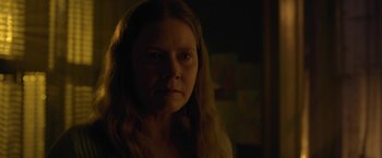 Movie still from “The Woman in the Window” (2021), directed by Joe Wright – A person in a dark room; Close Up shot, Over the shoulder angle