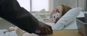 Movie still from “The Woman in the Window” (2021), directed by Joe Wright – A woman in a hospital bed with a broken eye; Close Up shot, Over the shoulder angle