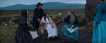 Movie still from “The Wonder” (2022), directed by Sebastián Lelio – Wide shot, Over the shoulder angle