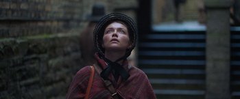 Movie still from “The Wonder” (2022), directed by Sebastián Lelio – A woman wearing a hat looking up into the sky; Close Up shot, Low angle