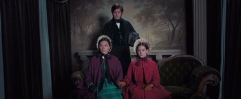 Movie still from “The Wonder” (2022), directed by Sebastián Lelio – A man and two women in period clothing; Medium shot, Low angle