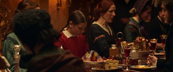 Movie still from “The Wonder” (2022), directed by Sebastián Lelio – A woman and a girl sitting at a dinner table; Medium shot, Over the shoulder angle
