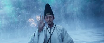 Movie still from “The Yin-Yang Master: Dream of Eternity” (2020), directed by Jingming Guo – A man in traditional chinese garb holding up a peace sign; Medium shot, Low angle