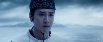 Movie still from “The Yin-Yang Master: Dream of Eternity” (2020), directed by Jingming Guo – A young man wearing a hat and looking at the camera; Close Up shot, Low angle