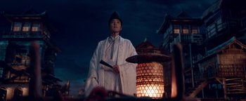 Movie still from “The Yin-Yang Master: Dream of Eternity” (2020), directed by Jingming Guo – A man dressed in a white robe and a green hat holding a sword; Medium shot, Low angle