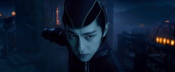 Movie still from “The Yin-Yang Master: Dream of Eternity” (2020), directed by Jingming Guo – A man in a black jacket and a green hat; Close Up shot, Low angle