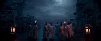 Movie still from “The Yin-Yang Master: Dream of Eternity” (2020), directed by Jingming Guo – A group of people standing in front of a body of water at night; Wide shot, Low angle