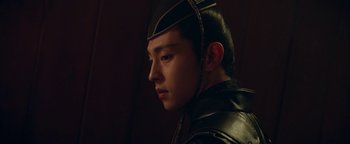 Movie still from “The Yin-Yang Master: Dream of Eternity” (2020), directed by Jingming Guo – A young man wearing a black leather jacket and a black hat; Close Up shot, Low angle