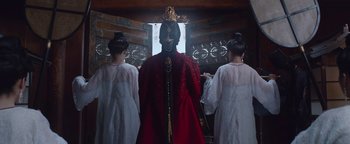 Movie still from “The Yin-Yang Master: Dream of Eternity” (2020), directed by Jingming Guo – Three people in traditional clothing standing in front of a window; Medium shot, Low angle