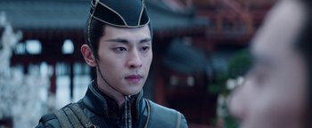 Movie still from “The Yin-Yang Master: Dream of Eternity” (2020), directed by Jingming Guo – A man in a black suit and a black hat; Close Up shot, Over the shoulder angle