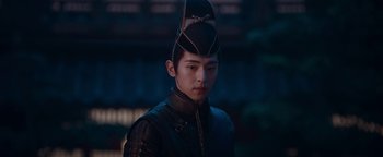 Movie still from “The Yin-Yang Master: Dream of Eternity” (2020), directed by Jingming Guo – A young man wearing a black hat and a black jacket; Close Up shot, Low angle