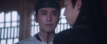 Movie still from “The Yin-Yang Master: Dream of Eternity” (2020), directed by Jingming Guo – A man in a black hat is looking at another man in a black hat; Close Up shot, Over the shoulder angle