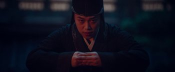 Movie still from “The Yin-Yang Master: Dream of Eternity” (2020), directed by Jingming Guo – A man wearing a black hat and a black robe; Medium shot, Low angle