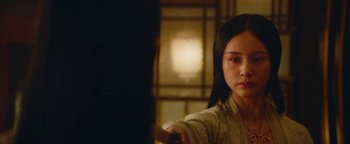 Movie still from “The Yin-Yang Master: Dream of Eternity” (2020), directed by Jingming Guo – A young woman holding a sword in front of a window; Close Up shot, Over the shoulder angle