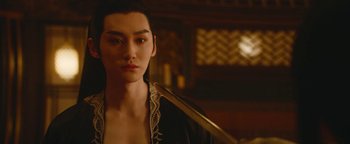 Movie still from “The Yin-Yang Master: Dream of Eternity” (2020), directed by Jingming Guo – A person holding a sword in a room; Close Up shot, Over the shoulder angle