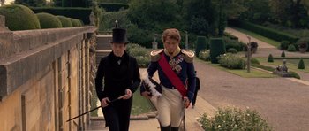 Movie still from “The Young Victoria” (2009), directed by Jean-Marc Vallée – A man in a uniform walking next to another man in a uniform; Medium shot, Over the shoulder angle