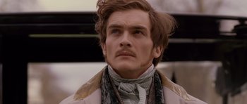 Movie still from “The Young Victoria” (2009), directed by Jean-Marc Vallée – A person wearing a coat and a scarf; Close Up shot, Low angle