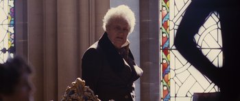 Movie still from “The Young Victoria” (2009), directed by Jean-Marc Vallée – An older man standing in front of a stained glass window; Close Up shot, Over the shoulder angle