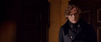 Movie still from “The Young Victoria” (2009), directed by Jean-Marc Vallée – A man in a black jacket standing in a room; Medium shot, Over the shoulder angle