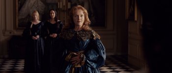 Movie still from “The Young Victoria” (2009), directed by Jean-Marc Vallée – A woman in a blue dress standing next to another woman in a black dress; Medium shot, Over the shoulder angle