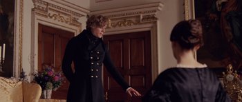 Movie still from “The Young Victoria” (2009), directed by Jean-Marc Vallée – A woman in a black coat standing in front of a door; Medium shot, Over the shoulder angle