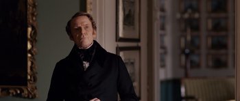 Movie still from “The Young Victoria” (2009), directed by Jean-Marc Vallée – A person wearing a suit and tie; Medium shot, Over the shoulder angle