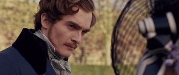 Movie still from “The Young Victoria” (2009), directed by Jean-Marc Vallée – A person wearing a suit and tie; Close Up shot, Over the shoulder angle