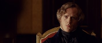 Movie still from “The Young Victoria” (2009), directed by Jean-Marc Vallée – A person sitting in a chair; Close Up shot, Over the shoulder angle