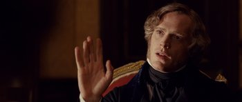 Movie still from “The Young Victoria” (2009), directed by Jean-Marc Vallée – A person sitting in a chair; Close Up shot, Over the shoulder angle