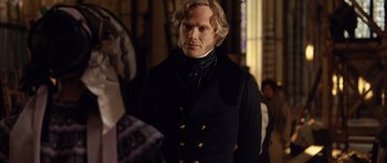 Movie still from “The Young Victoria” (2009), directed by Jean-Marc Vallée – A person wearing a suit and tie; Medium shot, Over the shoulder angle