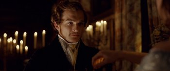 Movie still from “The Young Victoria” (2009), directed by Jean-Marc Vallée – A man in a suit and tie holding a candle in his hand; Close Up shot, Over the shoulder angle