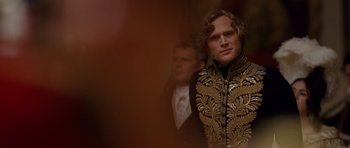 Movie still from “The Young Victoria” (2009), directed by Jean-Marc Vallée – A man in a black and gold jacket standing next to another man in a black suit; Close Up shot, Over the shoulder angle