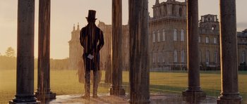 Movie still from “The Young Victoria” (2009), directed by Jean-Marc Vallée – A man in a top hat standing in front of a building; Wide shot, Over the shoulder angle