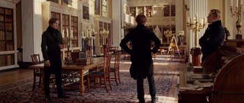 Movie still from “The Young Victoria” (2009), directed by Jean-Marc Vallée – A man standing in a room filled with furniture; Wide shot, Low angle