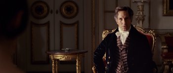 Movie still from “The Young Victoria” (2009), directed by Jean-Marc Vallée – A man in a suit sitting in front of a table; Medium shot, Over the shoulder angle