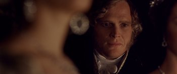Movie still from “The Young Victoria” (2009), directed by Jean-Marc Vallée – A person wearing a suit and tie; Close Up shot, Over the shoulder angle