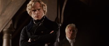 Movie still from “The Young Victoria” (2009), directed by Jean-Marc Vallée – A man standing next to another man wearing a suit; Close Up shot, Over the shoulder angle