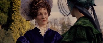 Movie still from “The Young Victoria” (2009), directed by Jean-Marc Vallée – An older woman wearing a blue dress and a blue hat; Close Up shot, Over the shoulder angle
