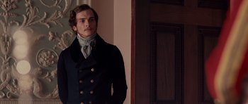 Movie still from “The Young Victoria” (2009), directed by Jean-Marc Vallée – A man wearing a black coat and a neck scarf; Medium shot, Over the shoulder angle