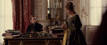 Movie still from “The Young Victoria” (2009), directed by Jean-Marc Vallée – A man and a woman are sitting at a desk; Medium shot, Over the shoulder angle