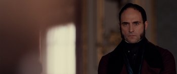 Movie still from “The Young Victoria” (2009), directed by Jean-Marc Vallée – A person wearing a suit and tie; Close Up shot, Over the shoulder angle