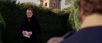 Movie still from “The Young Victoria” (2009), directed by Jean-Marc Vallée – A man standing in front of bushes and trees; Medium shot, Over the shoulder angle