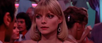 Movie still from “Scarface” (1983), directed by Brian De Palma – A person wearing a dress; Close Up shot, Over the shoulder angle