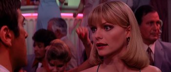 Movie still from “Scarface” (1983), directed by Brian De Palma – A person wearing a dress; Close Up shot, Over the shoulder angle